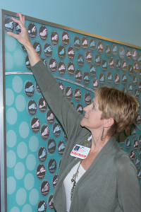 woman adding picture to board