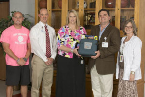 Pictured (L-R): Brandon Harbinson, Arndt Athletic Director, Marcus Osborne LAT, ATC, CVMC’s Director of Sports Medicine, Angela Williams, Arndt Principal, Carl Becker, RT(R), (CV), Director, Angiography Services at CVMC, and Margaret Sides, Arndt School Nurse.